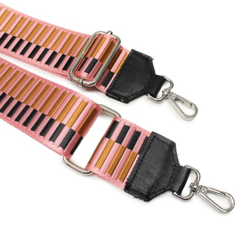 Pink bag strap with leather adjustments.